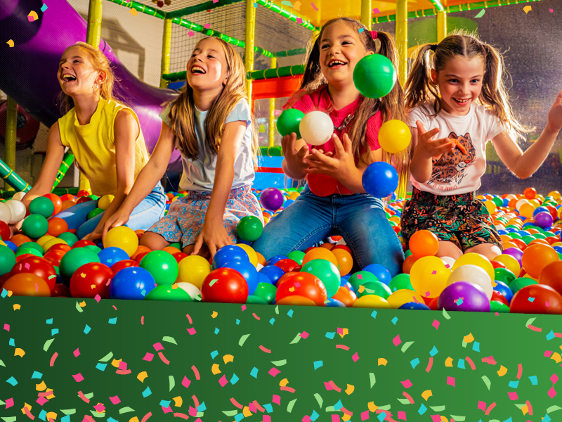 Happy children playing in a ballpit